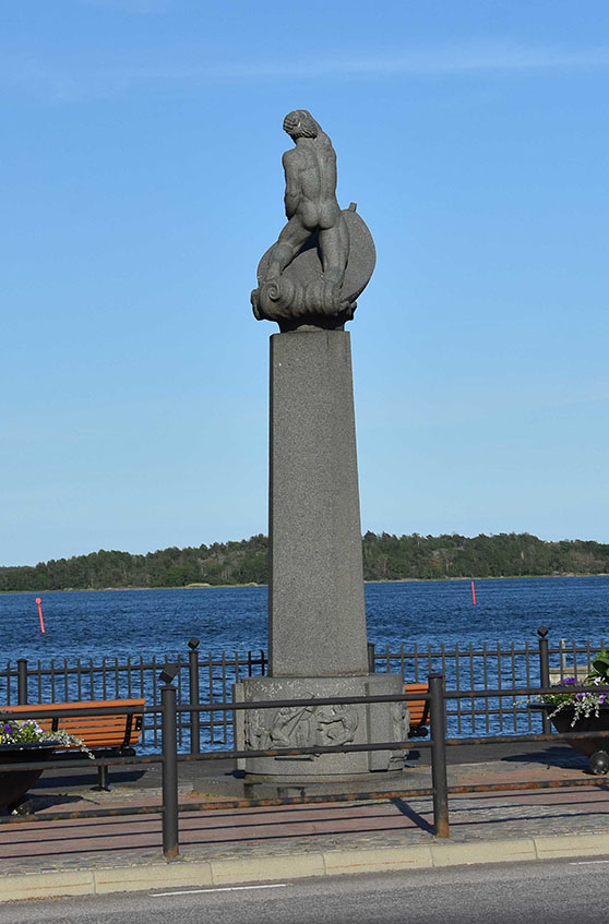 Konstverk med man som spejar över havet